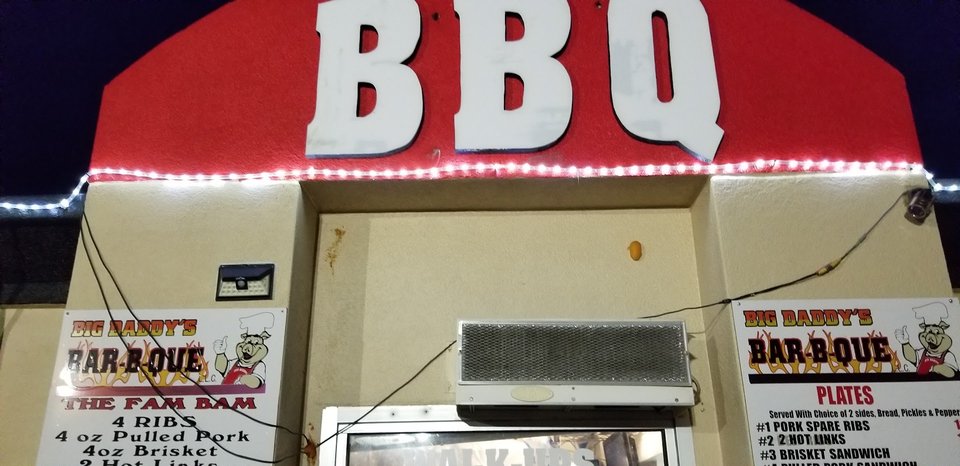 Smoked barbecue trays on a restaurant counter.