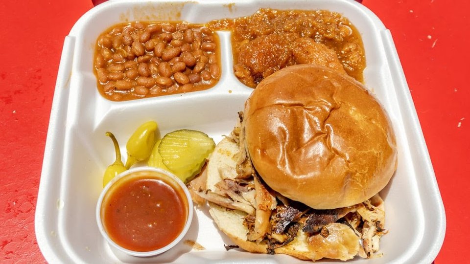 Printed menu with plates, sandwiches, and sides.